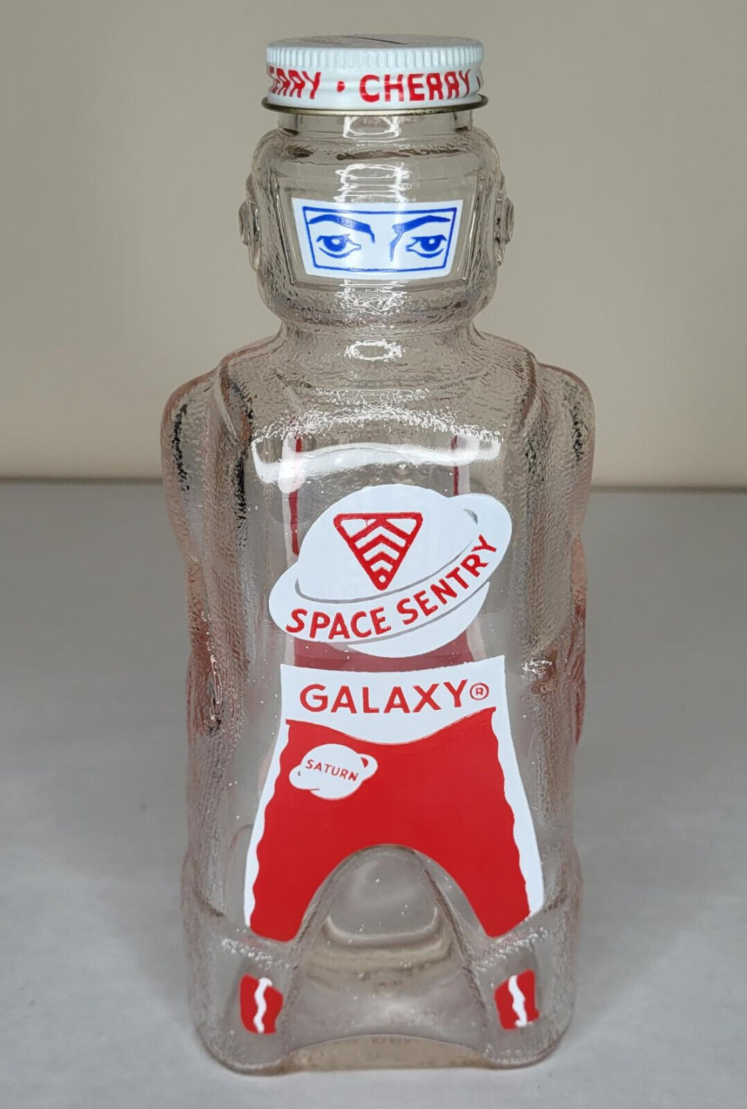 1950\'S GALAXY SPACE NAVIGATOR CHERRY SYRUP GLASS BOTTLE AND COIN BANK ROCKET JET