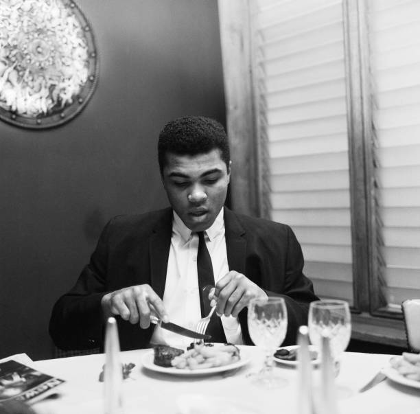 Cassius Clay having lunch London before trip to Scotland for a- 1965 Old Photo 1