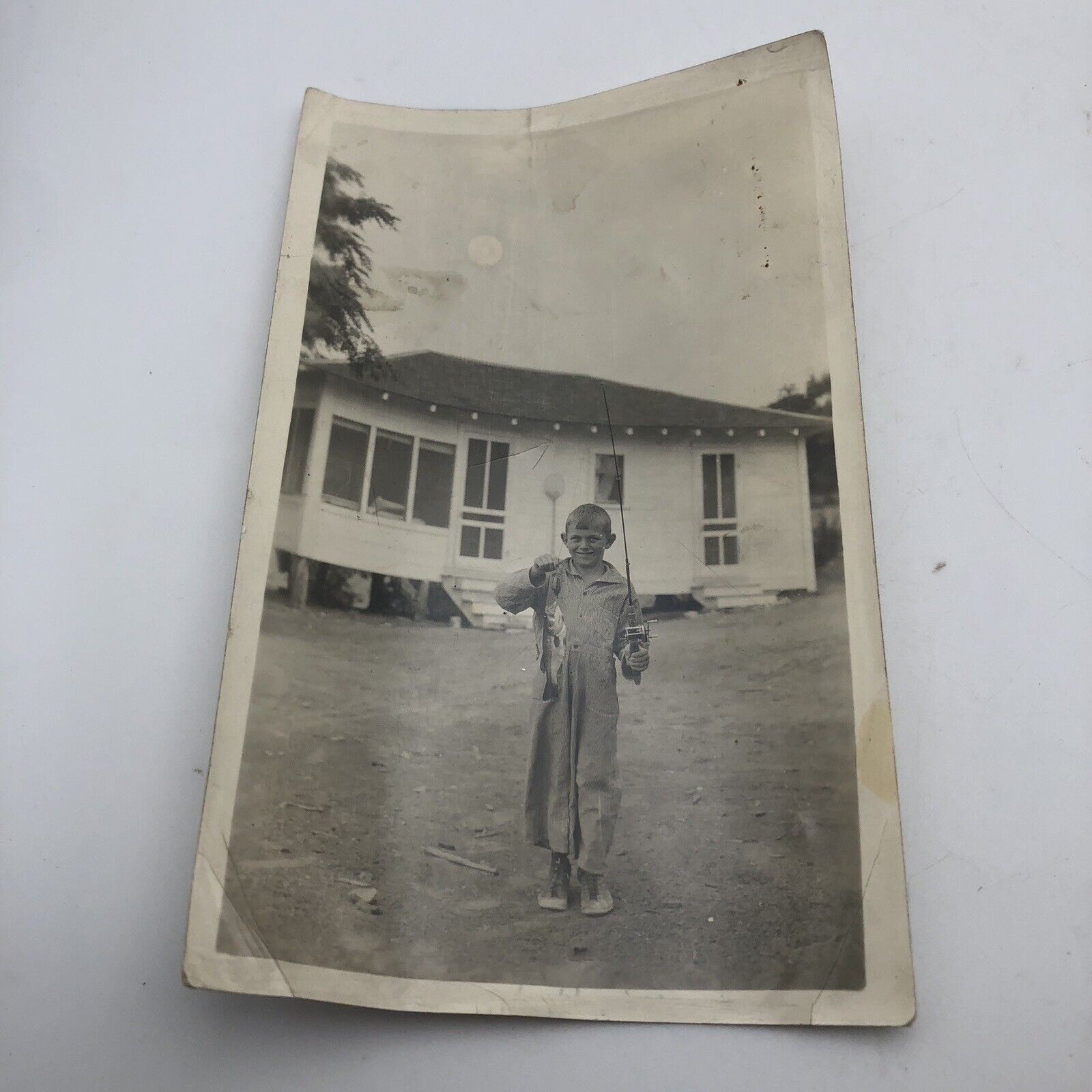 Antique Vintage Photo Smiling Boy Holding A Fish in Front Of House Ephemera B&W