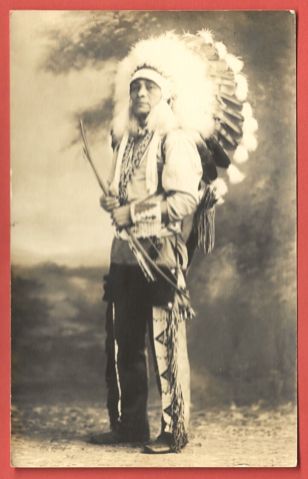 INDIAN CHIEF in WAR BONNET with BOW & ARROW – Real Photo Post Card