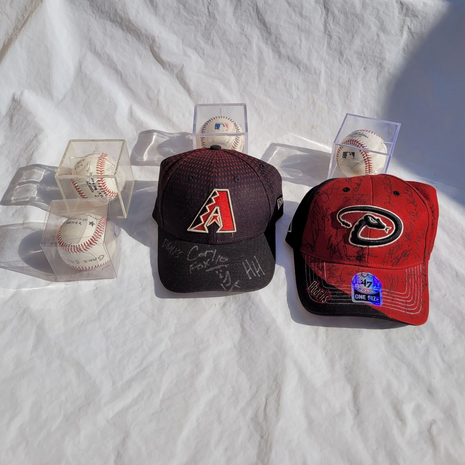 2 Arizona Diamondbacks Autographed Hats and 4 MLB Game Baseballs Signed