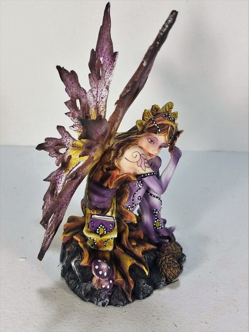 Purple Fairy Figurine Sitting by Pine Cones Backwoods Lighting LLC / 91469