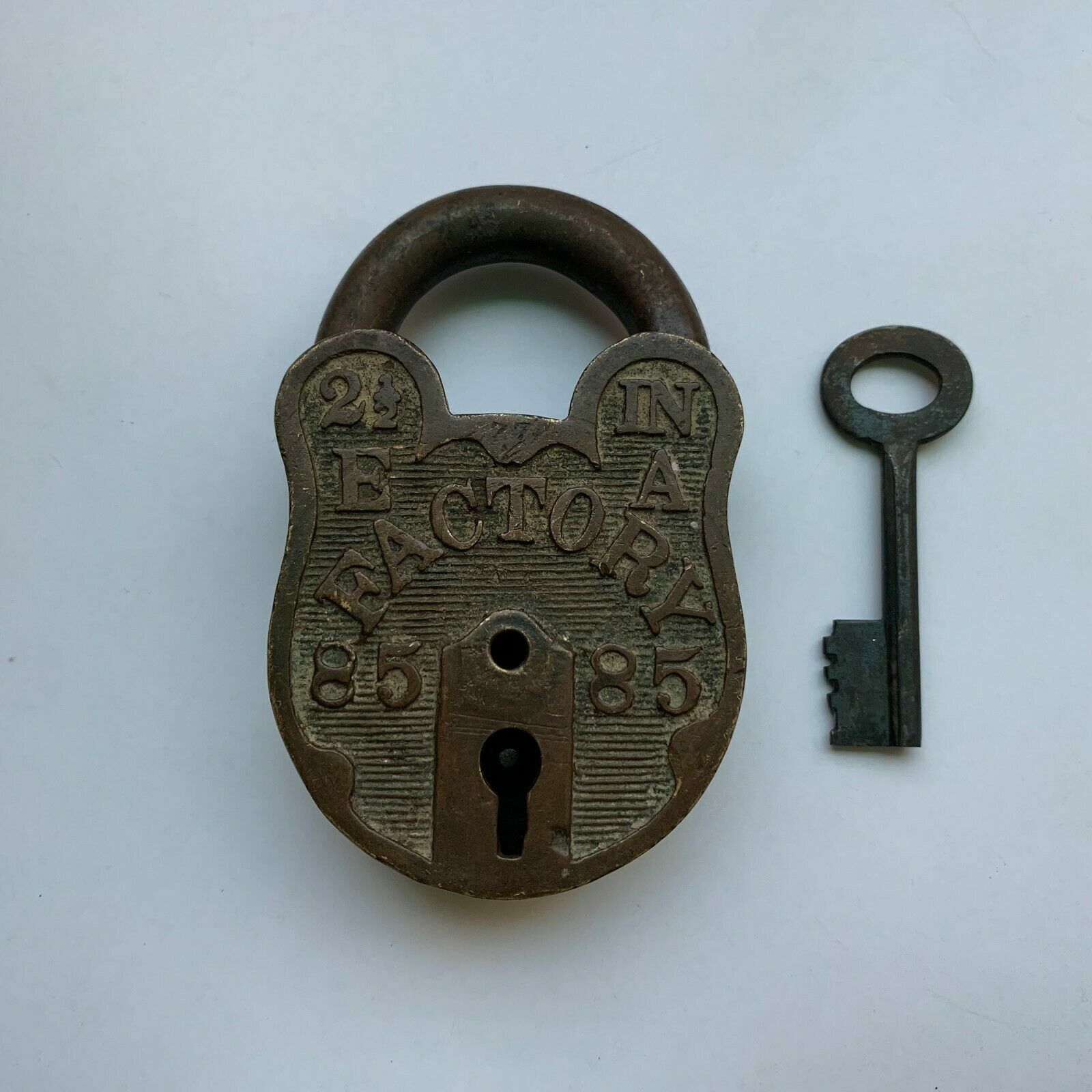 An old or antique brass padlock or lock with key collectible carving