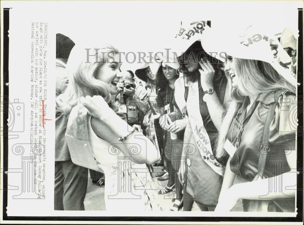 1972 Press Photo Tricia Cox tries on political banner at Miami airport.