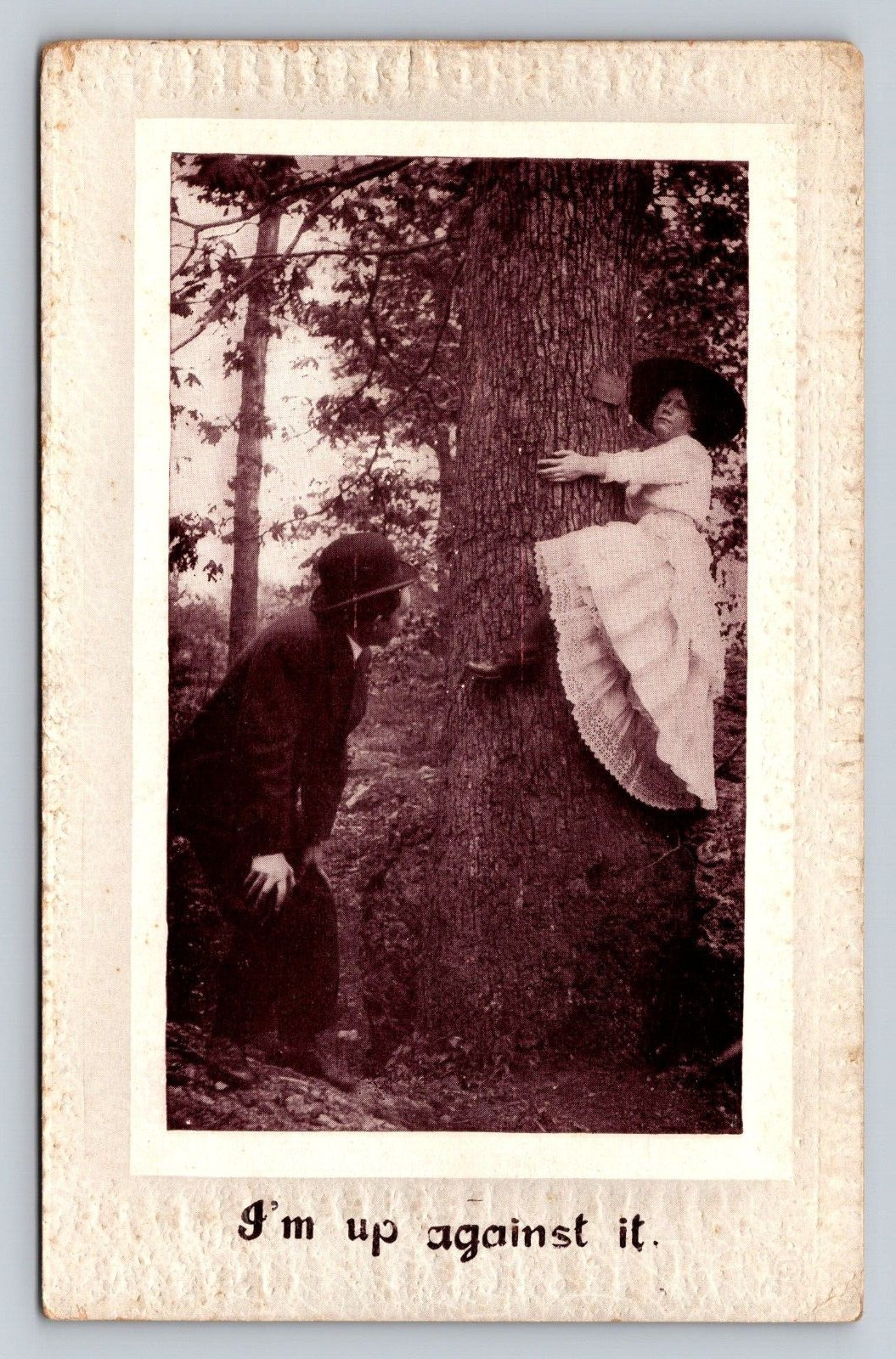 1915 Antique Postcard I'm Up Against It Man Admires Woman Straddling Big Tree