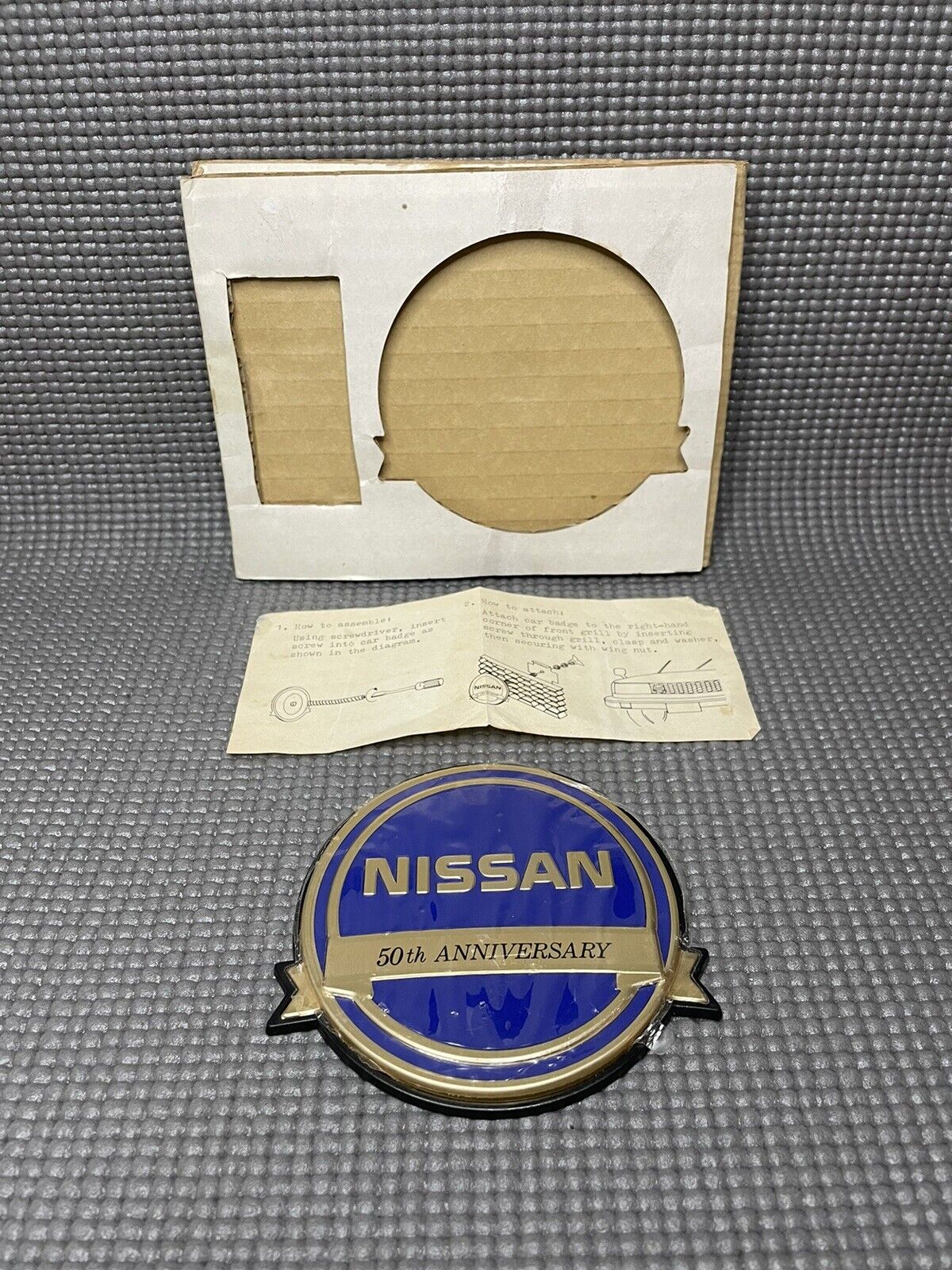 Vintage Nissan 50th Anniversary Badge Blue New Condition Badge Only