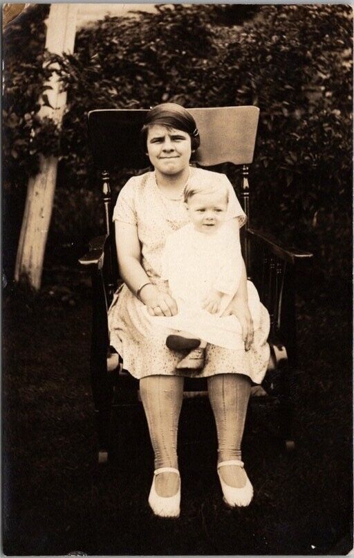 c1920s RPPC Photo Postcard Little Girl with Baby in Lap / Chair in House Yard