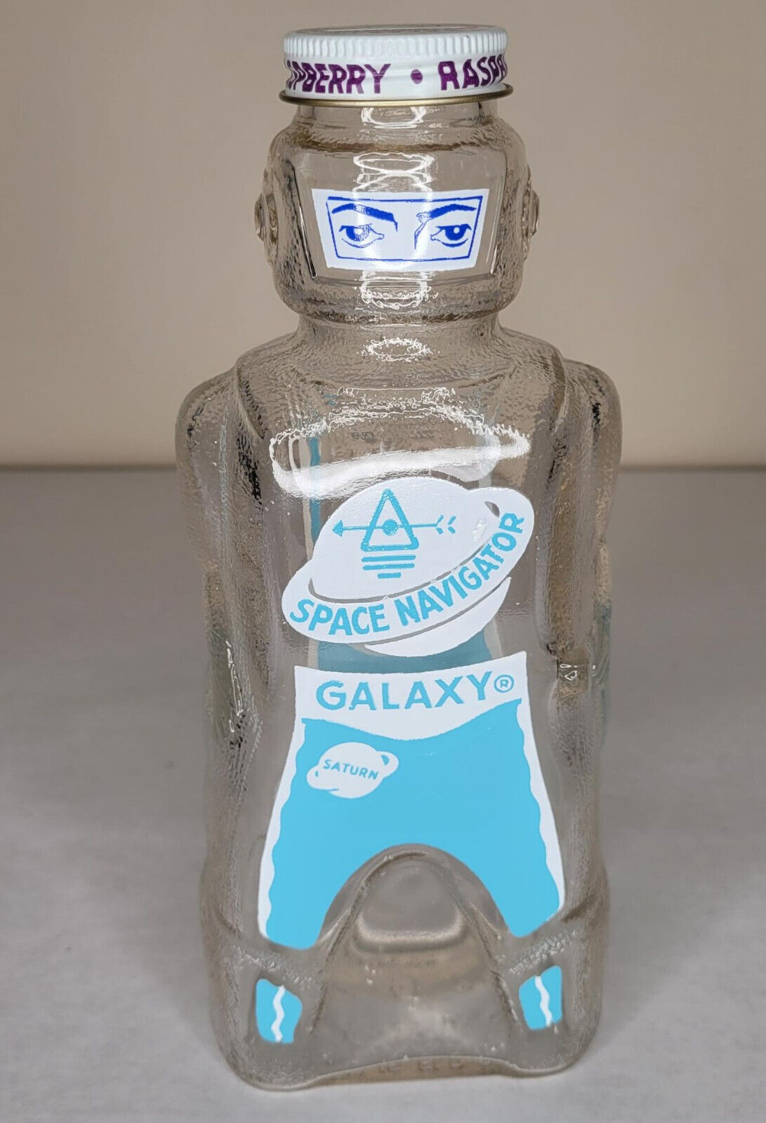 1950\'S GALAXY SPACE NAVIGATOR RASPBERRY SYRUP GLASS BOTTLE AND COIN BANK ROCKET