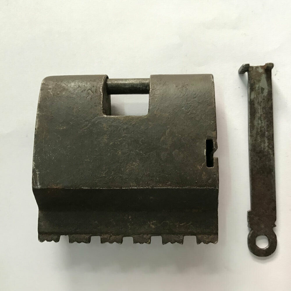 An antique Iron padlock or lock with key barbed spring mechanism