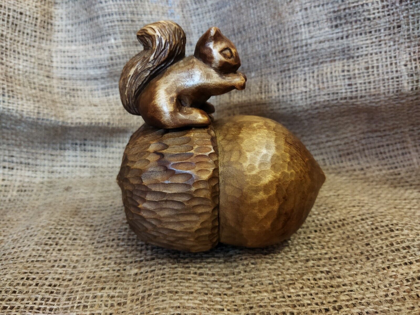 Composition of a squirrel with a wooden acorn. Wood carving. Handmade.
