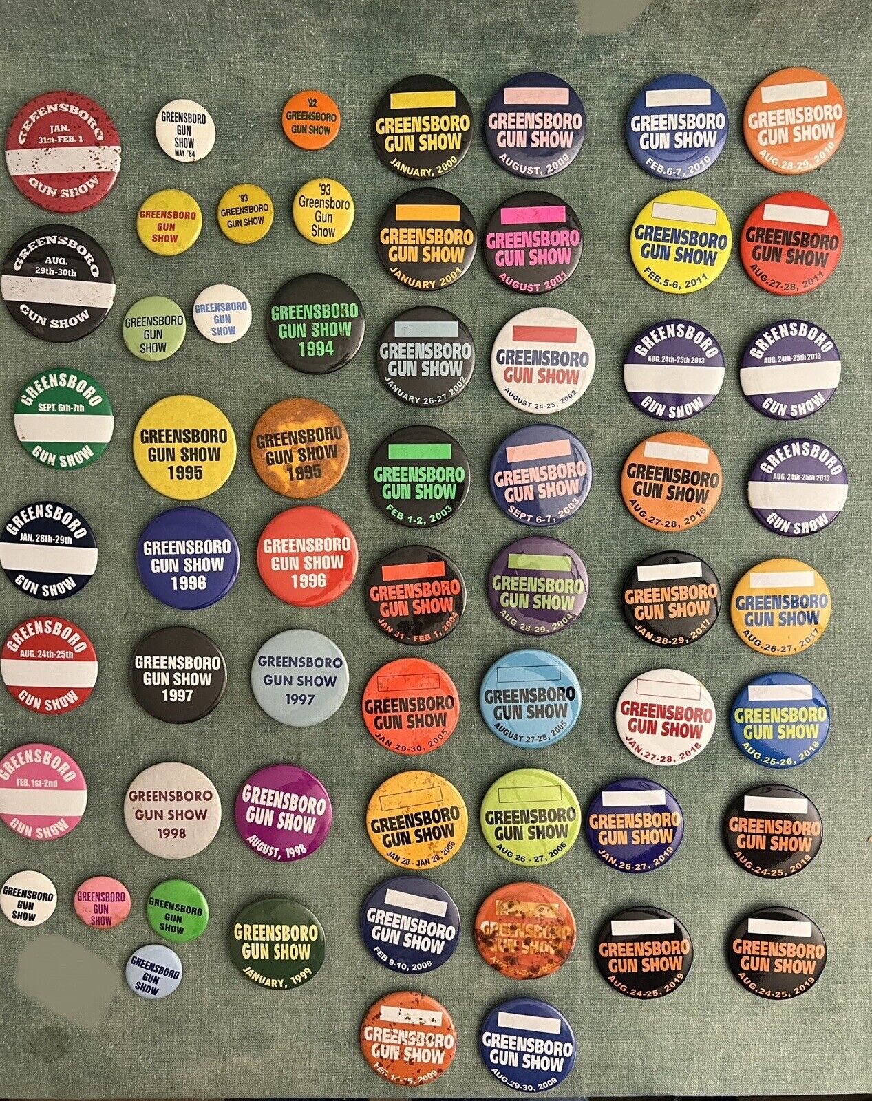 Lot of 60 Vintage & Recent Greensboro Gun Show Pin-back Buttons - From 1984-2019