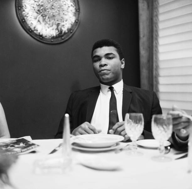 Cassius Clay having lunch London before trip to Scotland for a- 1965 Old Photo