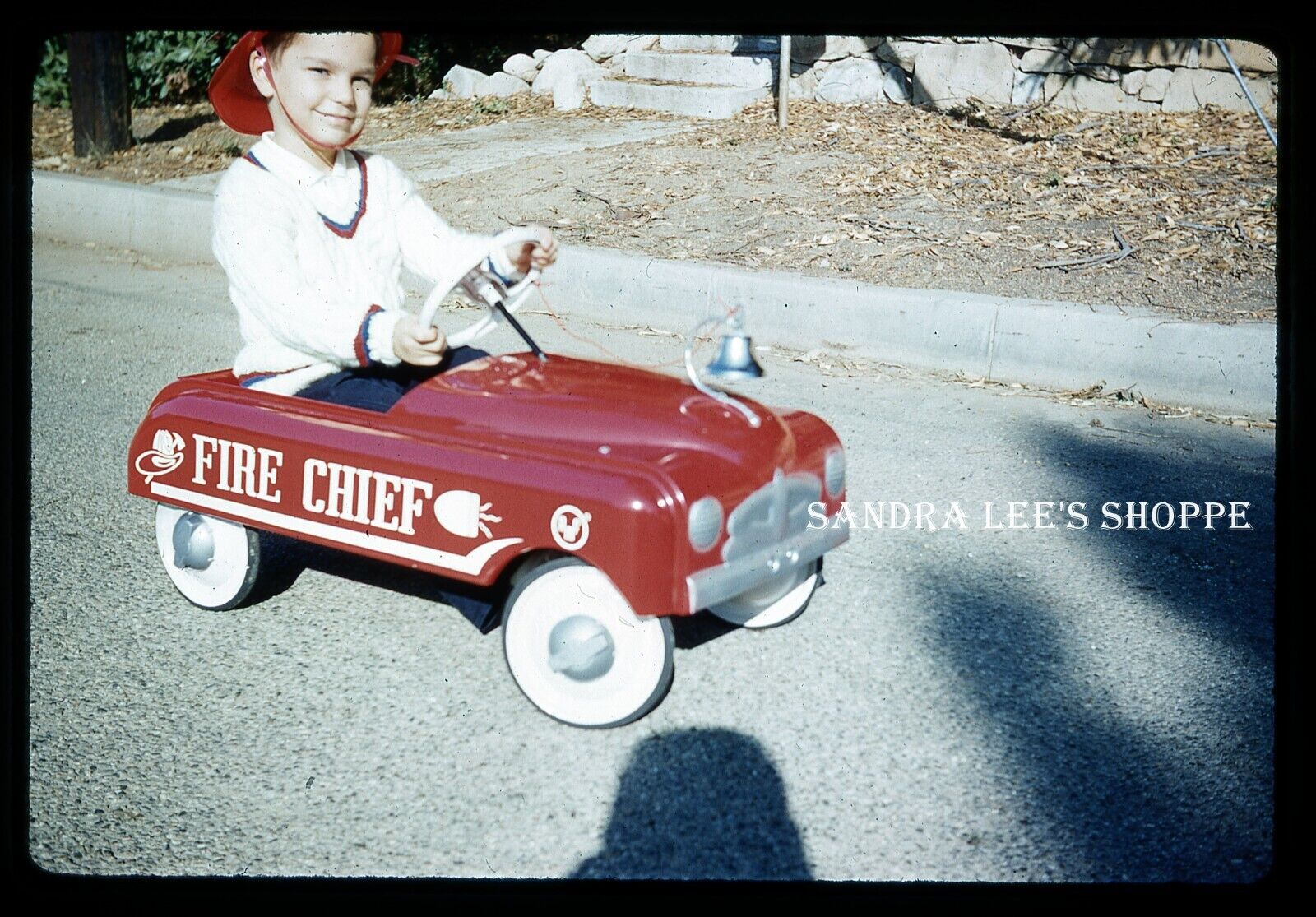#775 Slide 1959 Boy Riding Red Fire Chief Pedal Toy Car with Fireman Helmet
