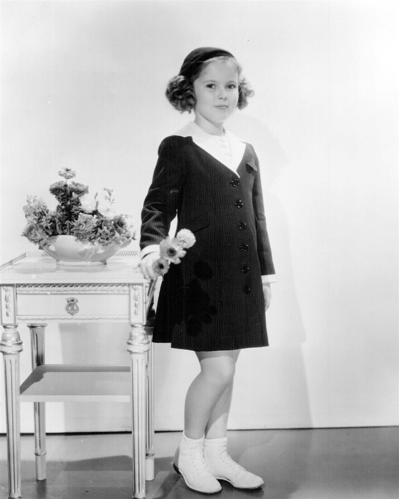 Shirley Temple holding flowers in coat and hat 4x6 inch photo