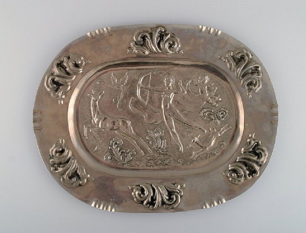 Swedish designer. Large oval serving dish in metal with classicist hunting scene