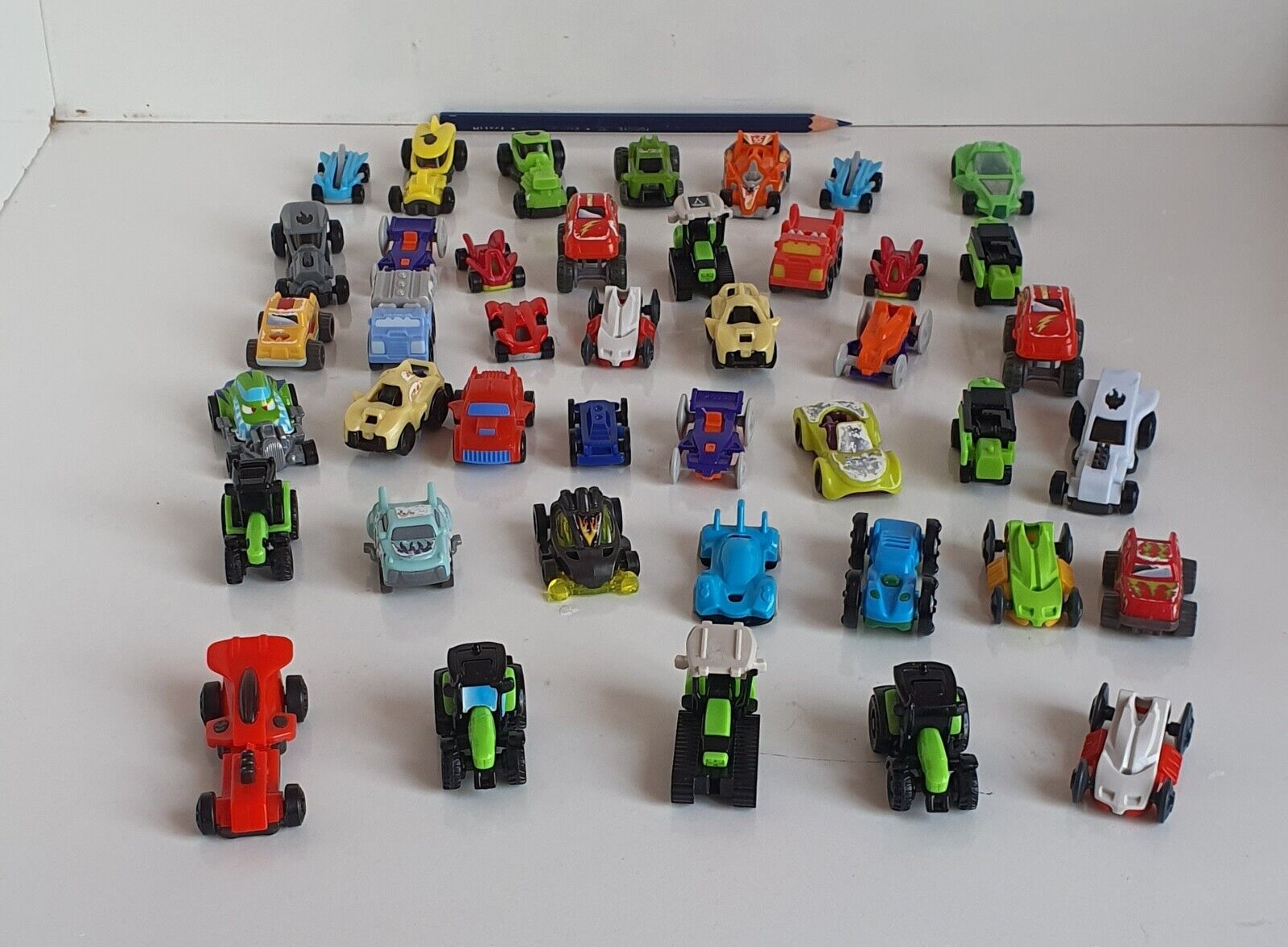 A set of 42 kinder car toys that are different from each other. 