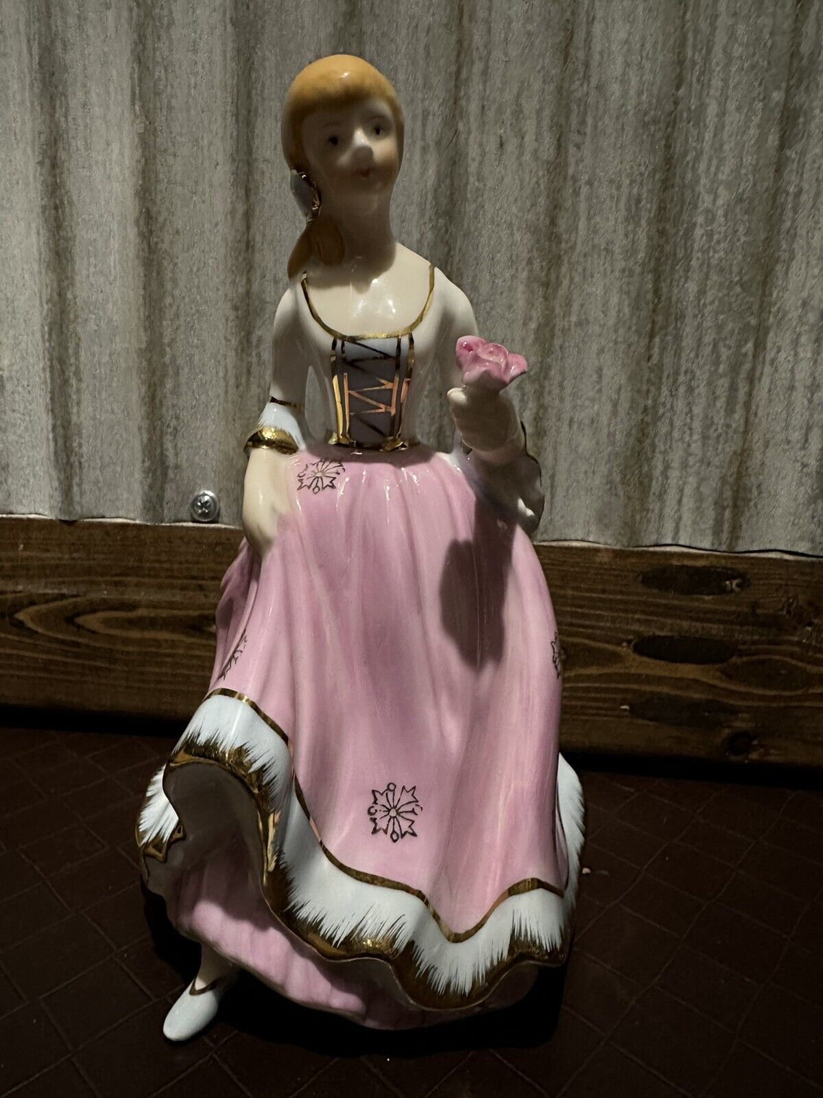 Beautiful Porcelain figurine lady holding flower in pink dress w/gold trim