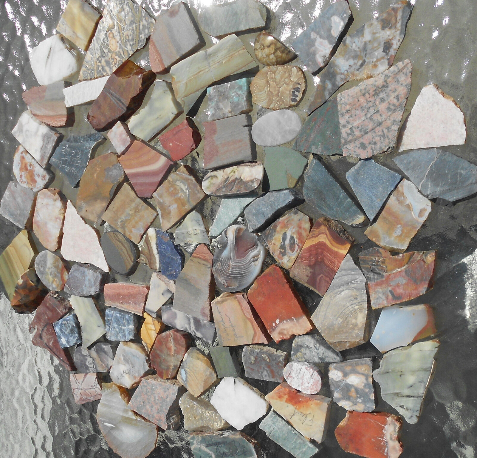 A variety of small semiprecious stone slab for over 100 cabachons, 1/4 in. thick