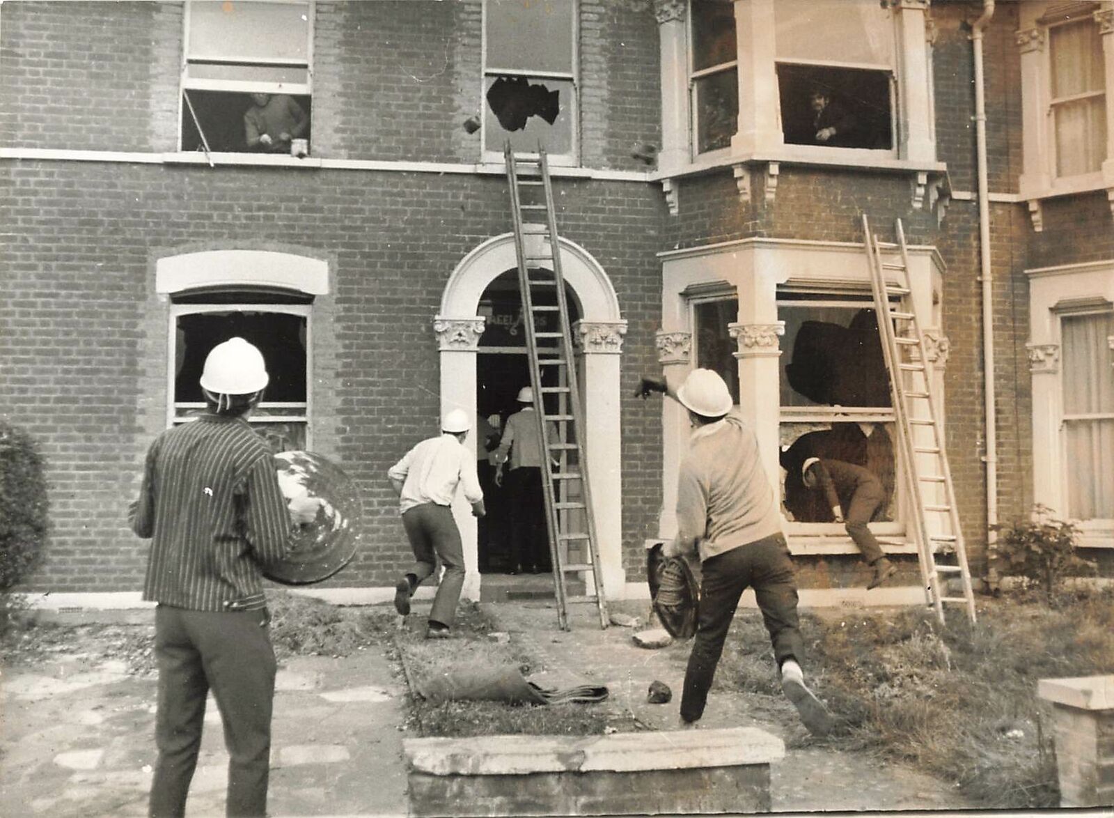 1969 Press Photo Bailiffs throw bricks in windows at Squatters Illford Essex kg