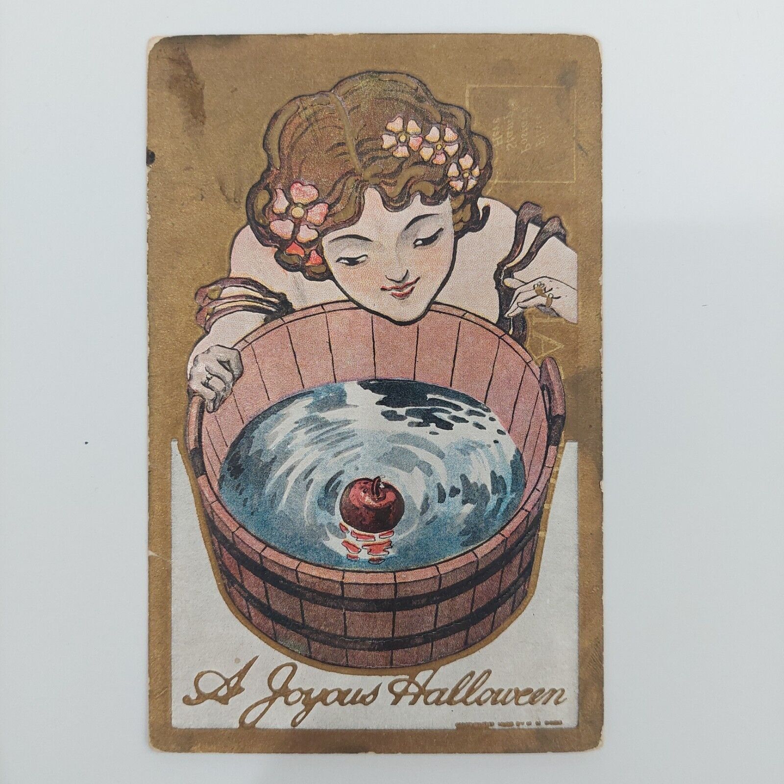 Vintage postcard c1914 A Joyous Halloween woman bobbing for apples