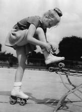 Girl from the Berlin Roller Skating Club laces up roller skates 1952 1953 Photo picture