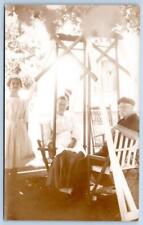 1910-20's RPPC FACE TO FACE DOUBLE GLIDER SWING TWIG CHAIR 3 PEOPLE POSTCARD picture
