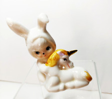 Vintage 1980s Figurine Pixie in Bunny Costume Hugging Unicorn picture