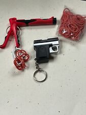 Lot of Red & Black Plastic Rubber Band & Faux Black & Silver Hand Gun Key Ring picture