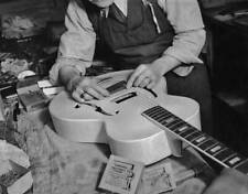 Man fitting bridge an Epiphone Electar guitar October 1940 Old Photo picture