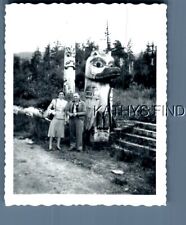 BLACK & WHITE PHOTO U_3219 MAN AND WOMAN POSED BY TOTEM POLES picture