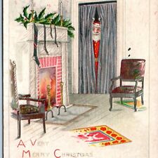 c1918 Santa Claus Hiding Christmas Postcard Embossed Tree Fireplace Rug Seat A76 picture