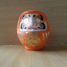 small Daruma Doll in orange color with a pen / Daruma at Takasaki : No 1 size picture