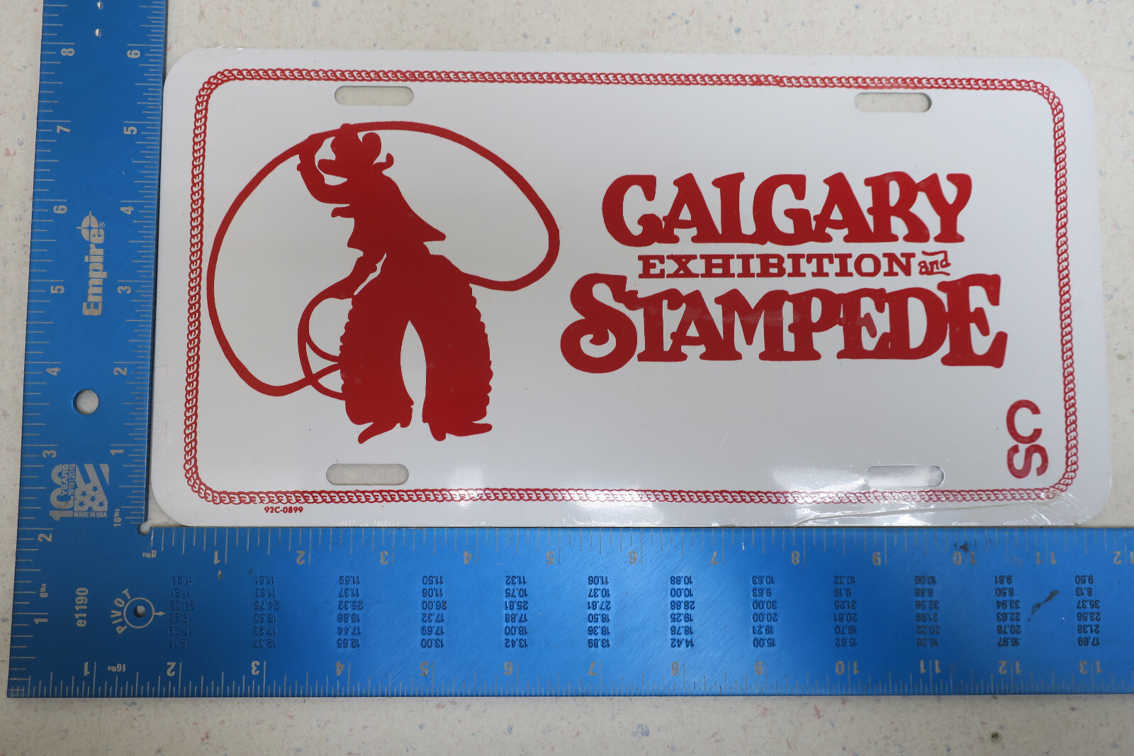 NOS FLAT CALGARY ALBERTA EXHIBITION STAMPEDE METAL BOOSTER LICENSE PLATE (BB1