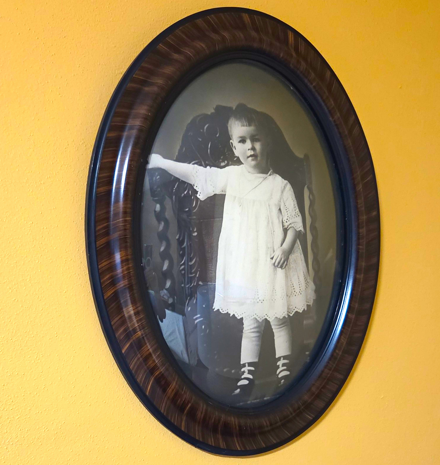 Antique oval portrait of child in tiger-stripe wooden frame convex bubble glass Antique oval portrait of child in tiger-stripe wooden frame convex bubble glass