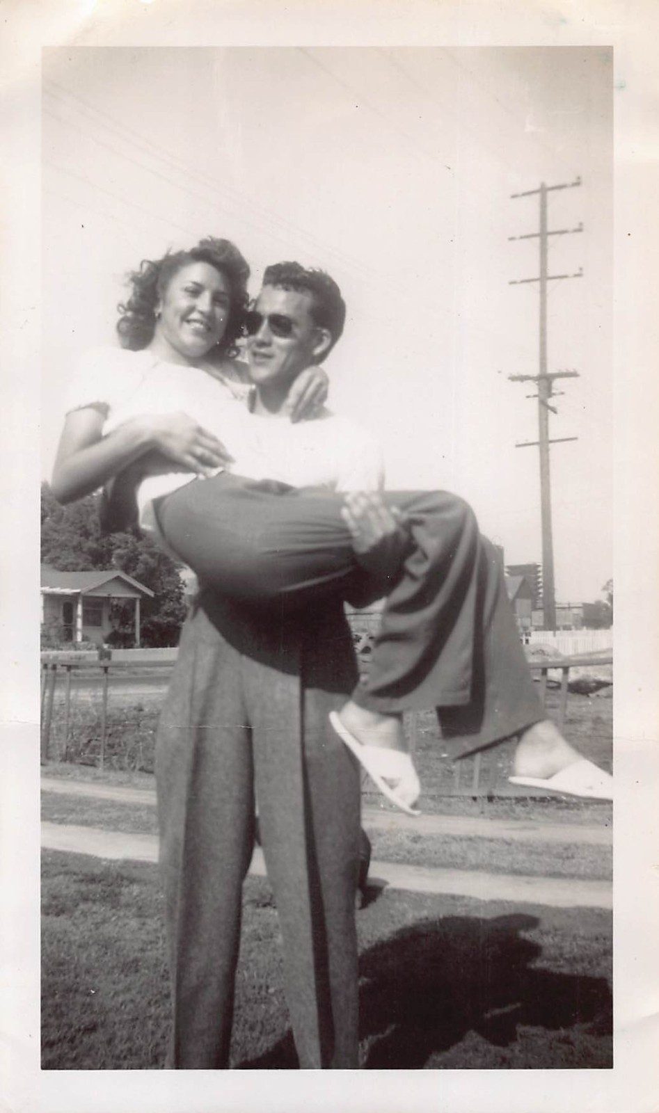 Young Man Lifting Holding Woman Front Yard 1940s Photo White Shirt Sunglasses Young Man Lifting Holding Woman Front Yard 1940s Photo White Shirt Sunglasses