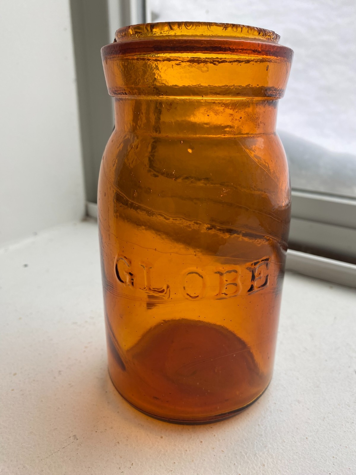 CRUDE AND SWIRLY AMBER GLOBE PINT FRUIT JAR