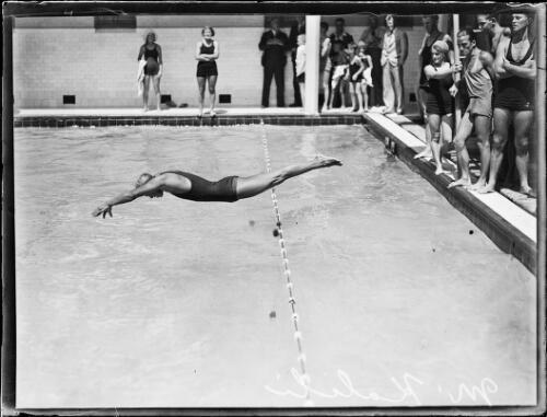 American swimmer Maiola Kalili diving into a pool with people watc- Old Photo