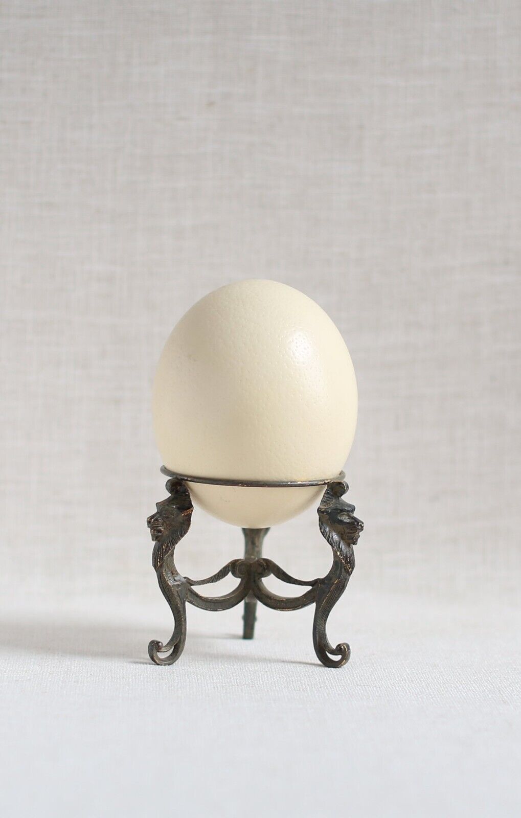 antique ostrich egg on stand with gilded lions