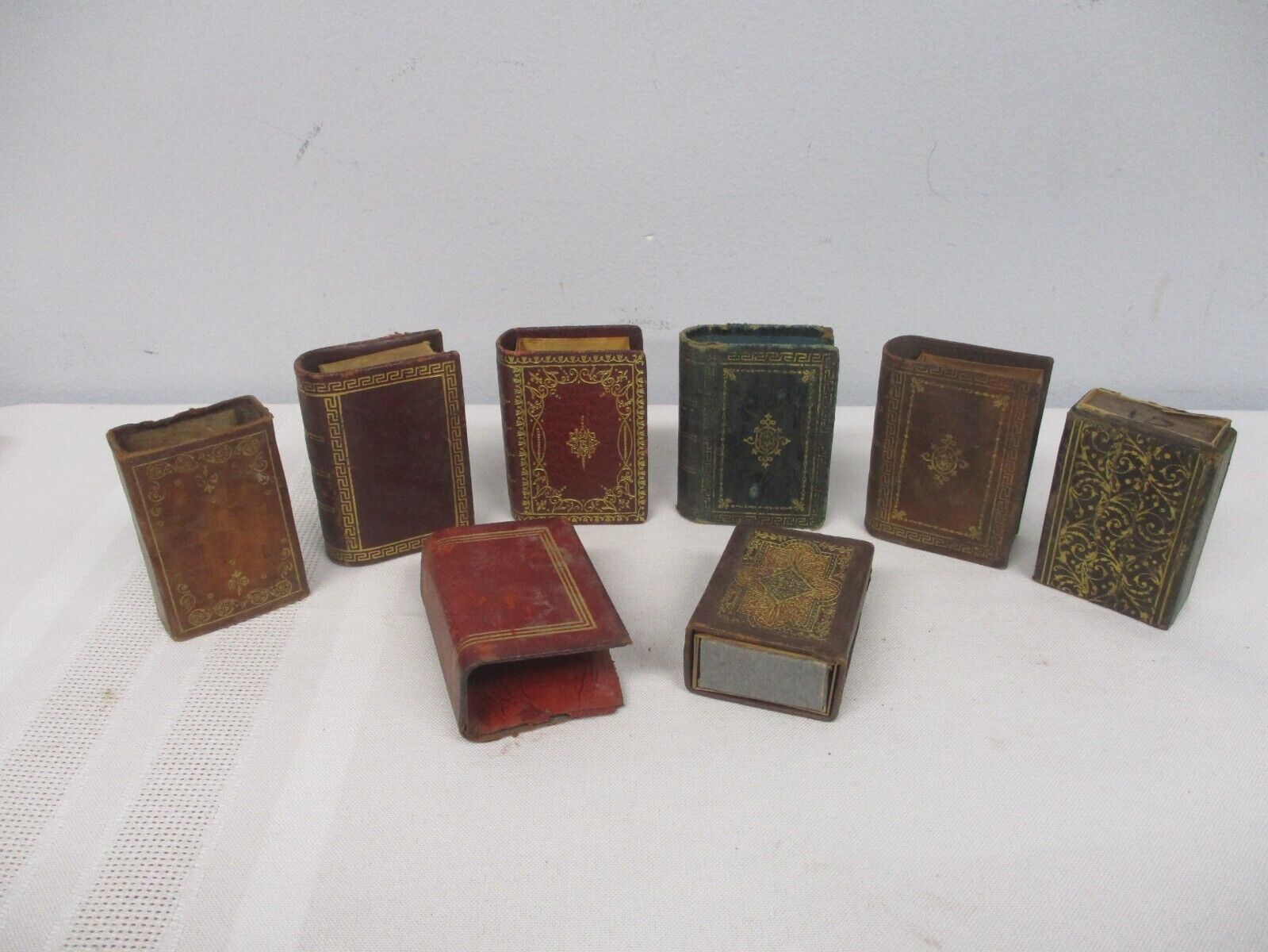 8 ANTIQUE LEATHER BOOK MATCH BOX HOLDERS