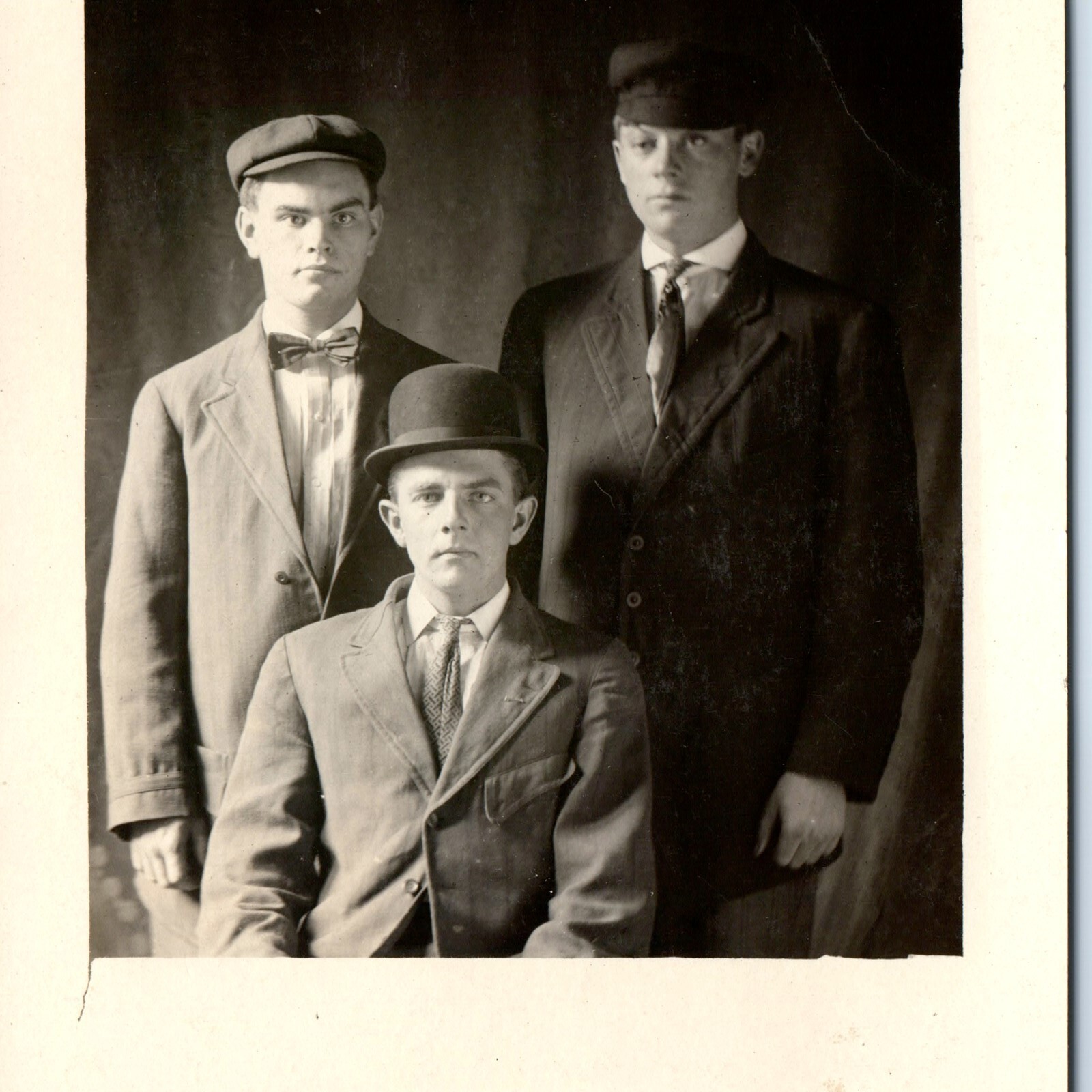 c1910s Three Handsome Young Men RPPC Bowler Derby Hat Flat Cap Bowtie Portrait c1910s Three Handsome Young Men RPPC Bowler Derby Hat Flat Cap Bowtie Portrait