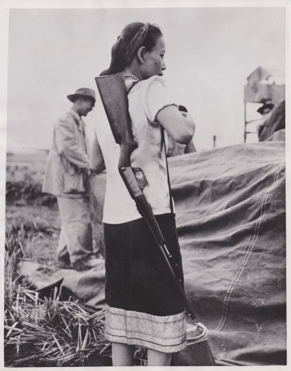 1953 Press Photo Armed Indo Chinese Housewife ready for Viet Minh Rebels in Laos