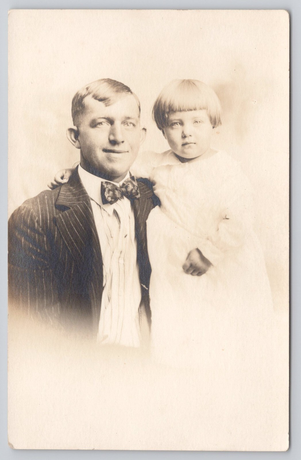 RPPC Portrait of Man Blond Hair Bowtie Holding Young Daughter 1918-1930 Postcard