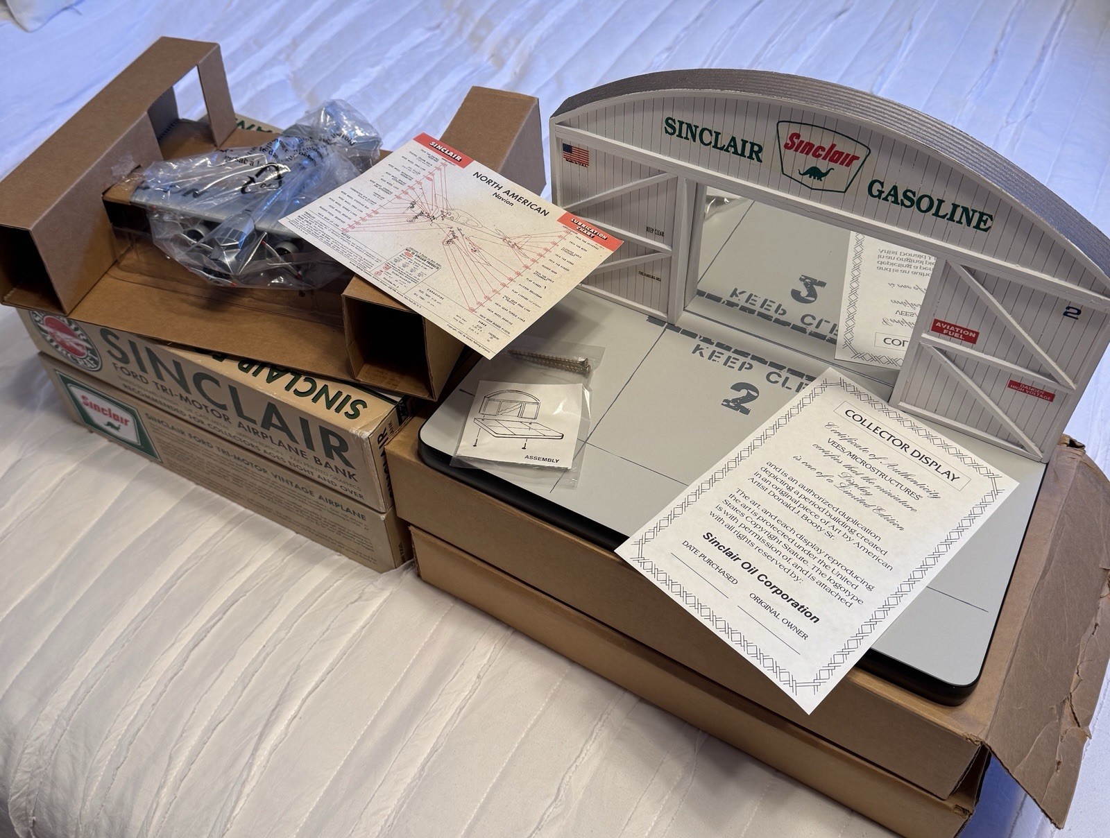 TWO NIB Sinclair Die Cast Ford Tri Motor Airplane Bank & Wooden Hangar Display