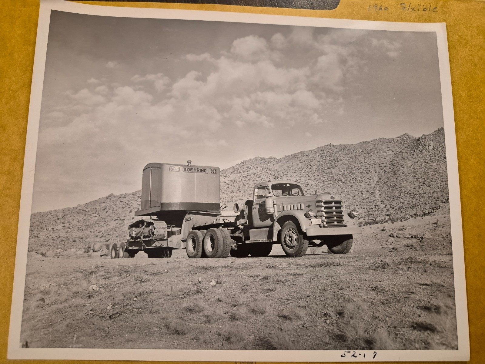 Old photo of a 1952 Diamond T Model 700 tractor hauling a excavator Old photo of a 1952 Diamond T Model 700 tractor hauling a excavator