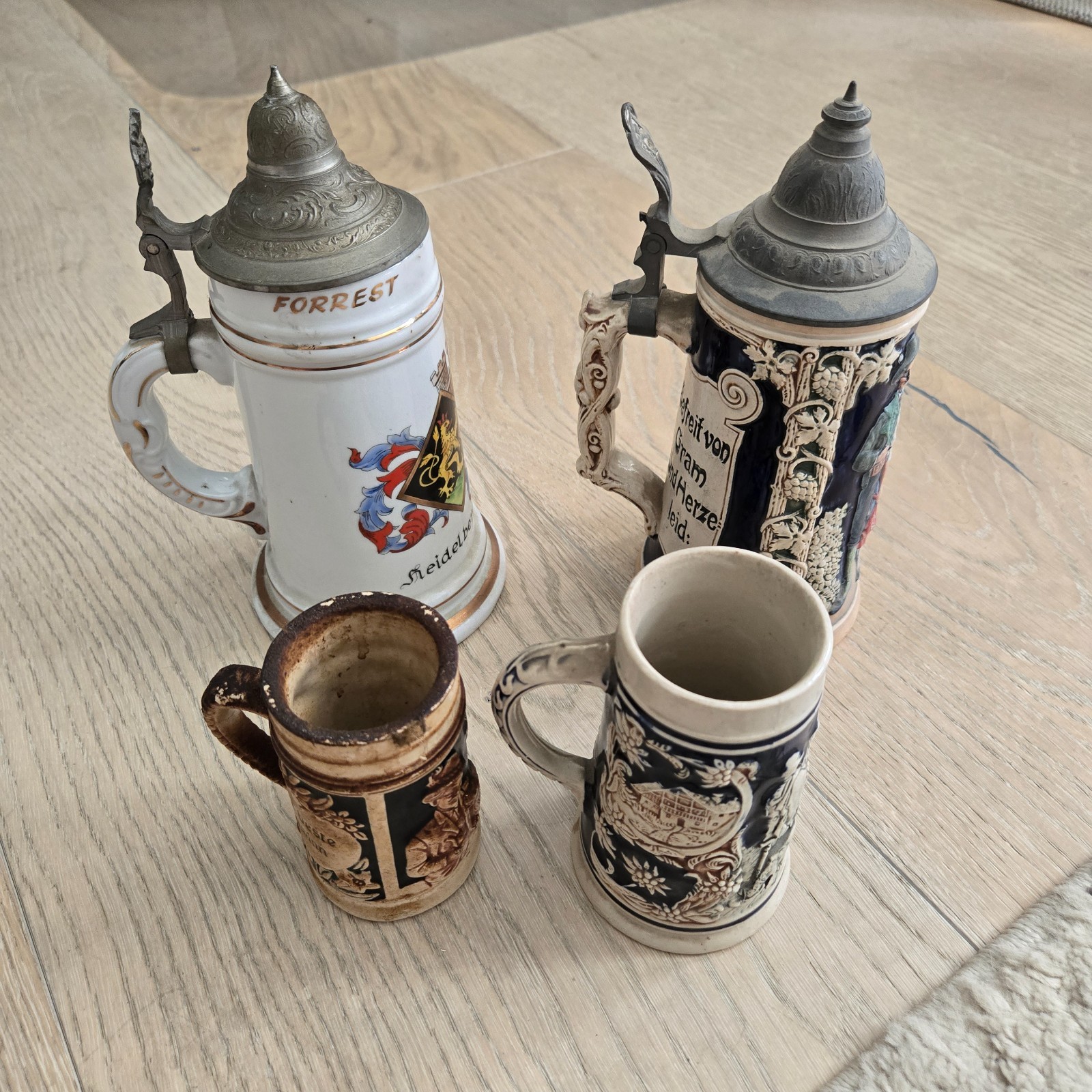 AN AWESOME, (LOT OF 4) GERMAN BEER STEINS. 5”-10”TALL AN AWESOME, (LOT OF 4) GERMAN BEER STEINS. 5”-10”TALL