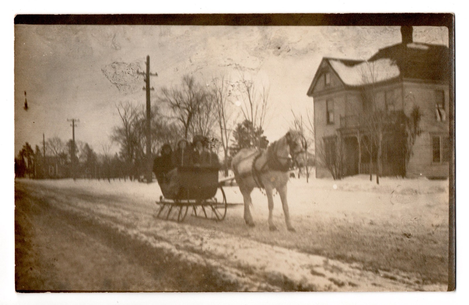 Vintage RPPC Winter Horse Drawn Sleigh Ride Family House Street Postcard