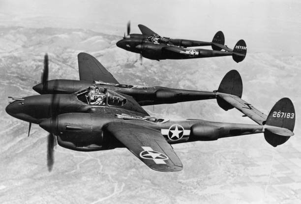 Two Lockhead P-38 Lightning aircraft fly Pacific Front during Worl- 1943 Photo