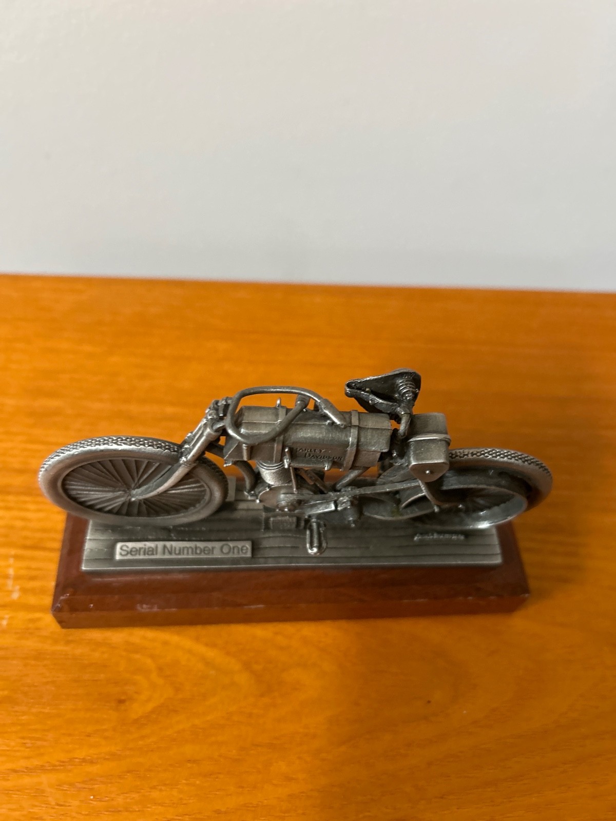 pewter replica of the Harley-Davidson Serial Number One motorcycle mounted on a pewter replica of the Harley-Davidson Serial Number One motorcycle mounted on a
