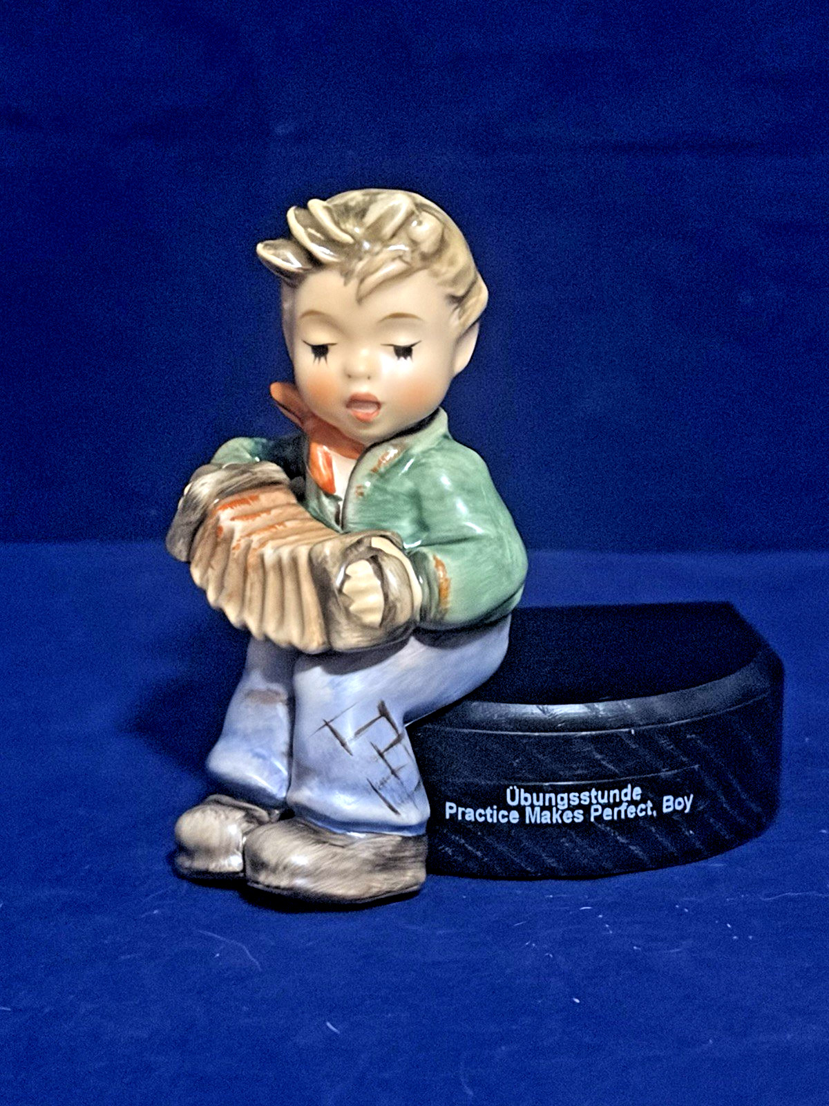 M.I. Hummel “Practice Makes Perfect, Boy” HUM 771 2/0 Porcelain Figurine w/Box M.I. Hummel “Practice Makes Perfect, Boy” HUM 771 2/0 Porcelain Figurine w/Box