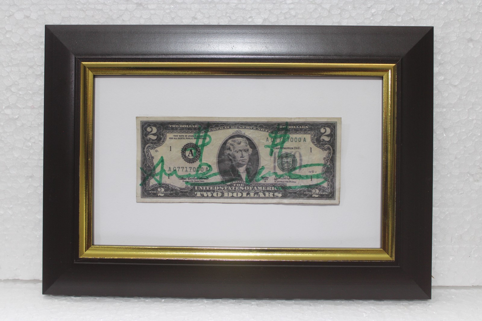 Two dollar bill signed by Andy Warhol with frame in good condition